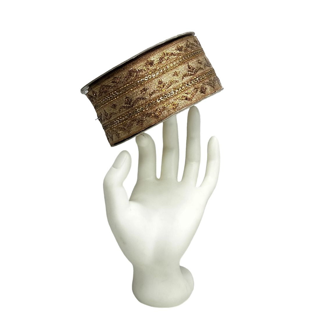 Decorative band on a white mannequin hand against a white background